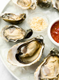 Freshly shucked oysters served on ice with accompaniments