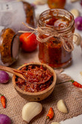 Illustrative image of red tomato-based sauce in a glass jar